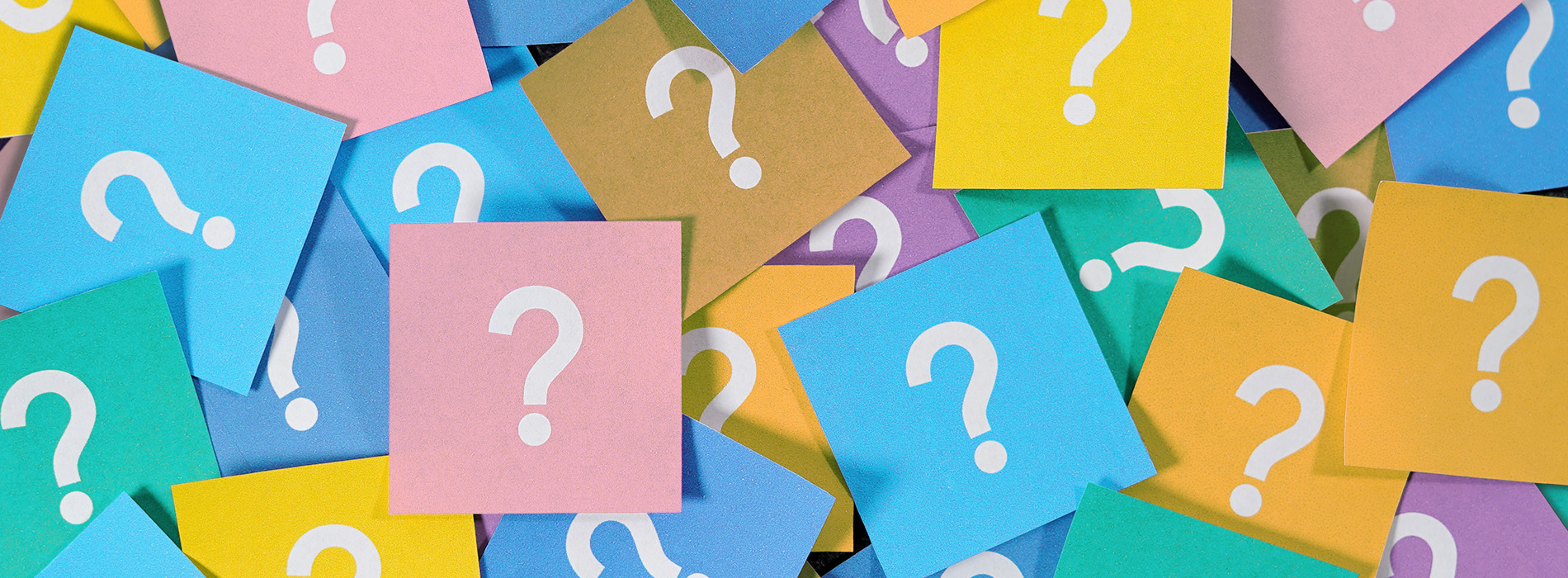 The image displays a collection of colorful sticky notes with question mark symbols on them, arranged together in a pattern.