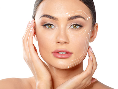 The image shows a woman with a neutral expression holding her face up to the camera, with a close-up view highlighting her facial features and skin texture.