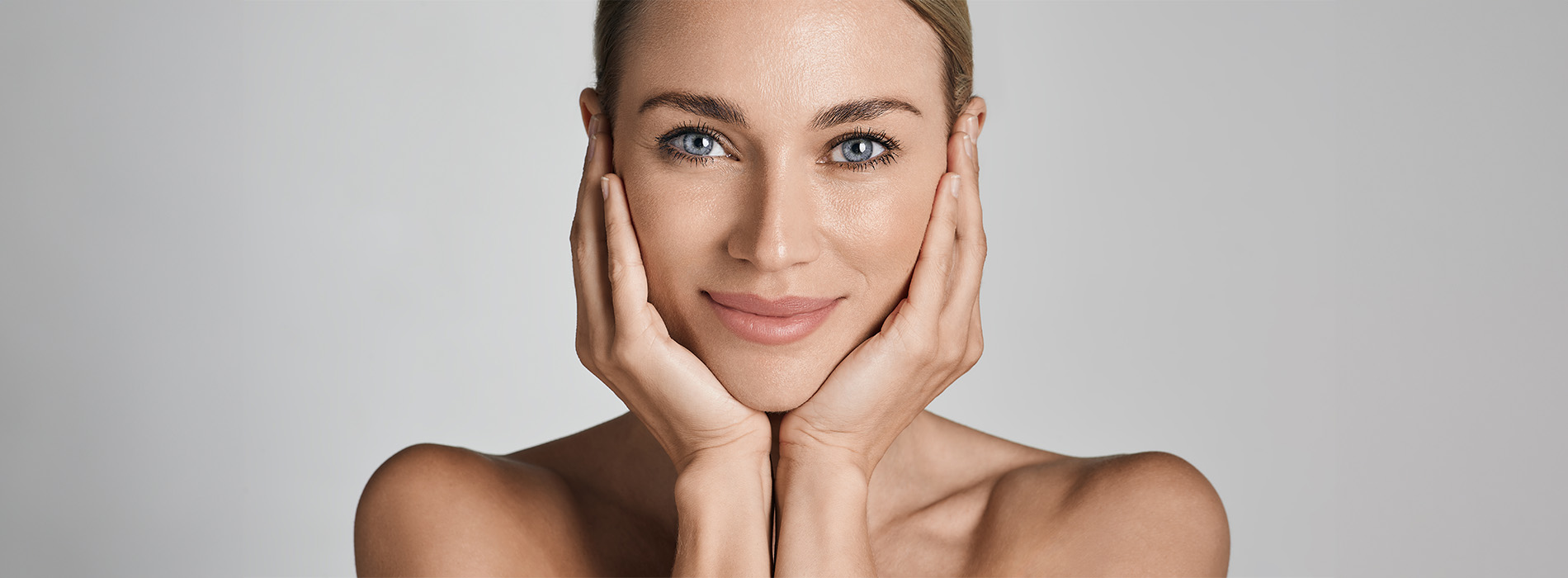 A woman with a confident expression, looking directly at the camera, set against a plain background.