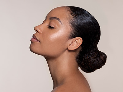 The image shows a person with their eyes closed, appearing to be in a meditative state, with a soft focus on their face against a neutral background.