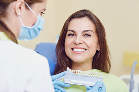 A woman receiving dental care from a professional in a dental office.